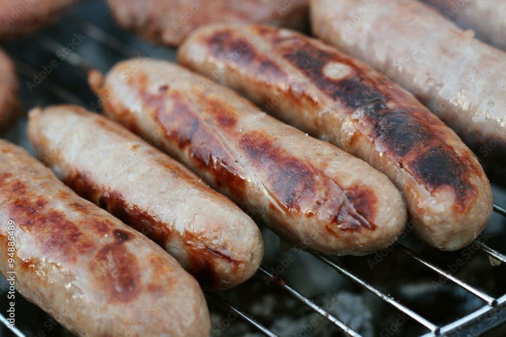 sausages and burgers cooking on barbecue sausages and burgers cooking on barbecue