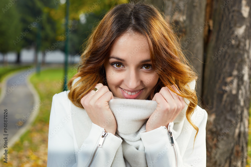 Portrait of cheerful young woman with autumn leafs in front of f Portrait of cheerful young woman with autumn leafs in front of f