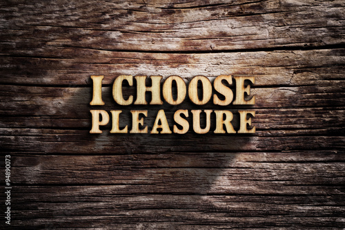 I choose Pleasure. Words on old wooden board. photo
