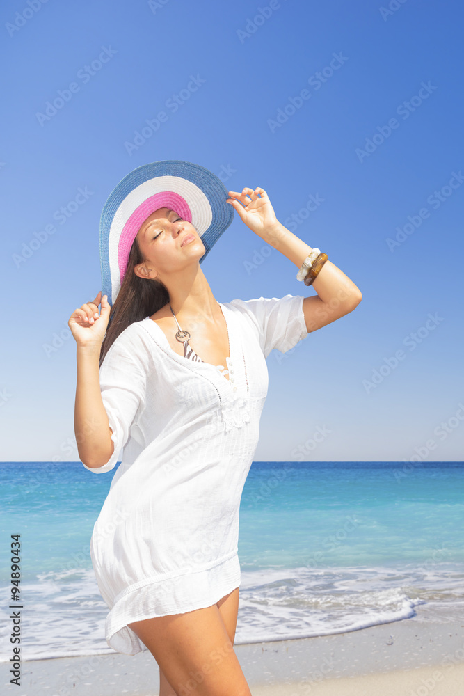 woman in white clothing refreshing at the ocean woman in white clothing refreshing at the ocean