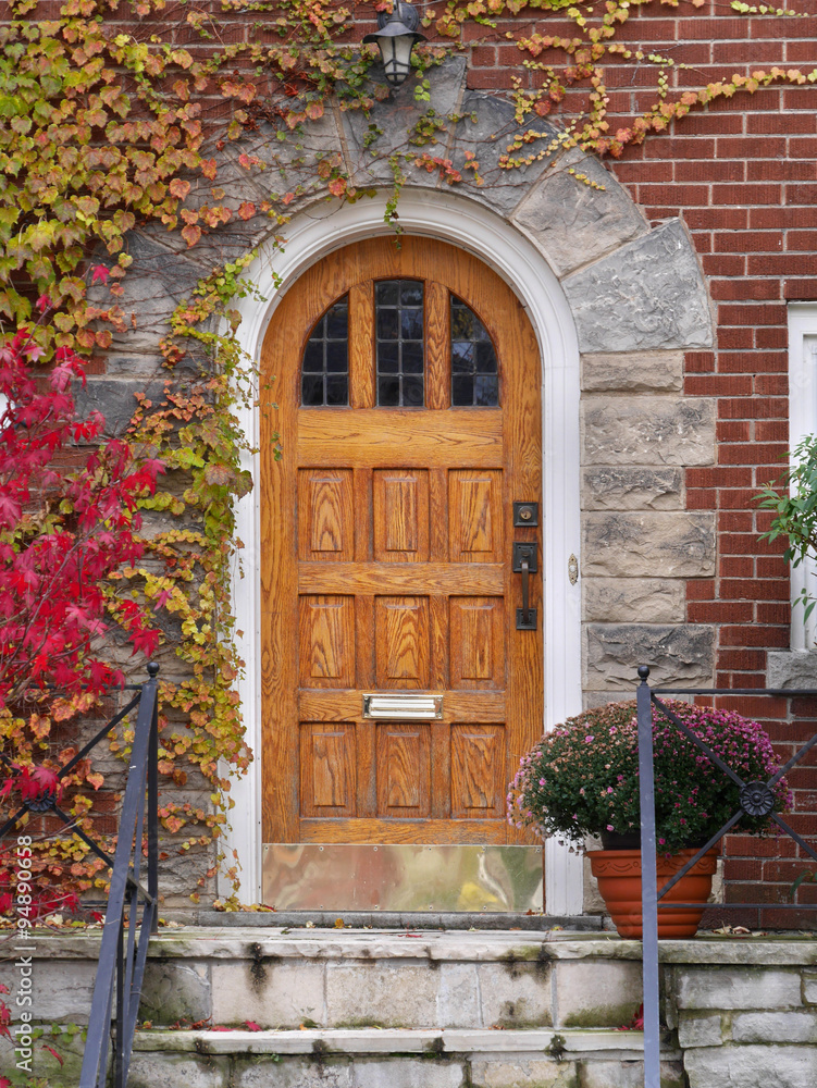Fototapeta premium wooden front door with colorful ivy in fall