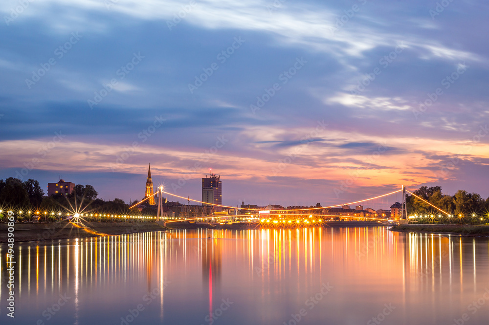 Fototapeta premium City landscape on a river at sunset