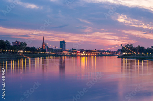 Fényképezés City landscape on a river at sunset
