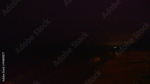 Thunderstorm and lightning flashes along coastline waterfront