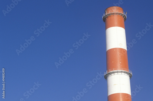 A red and white smoke stack at the Scattergood steam plant in Los Angeles, CA