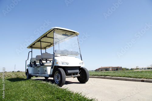 White golf carts at the green golf course