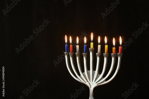 Image of jewish holiday Hanukkah background with menorah (traditional candelabra) and Burning candles