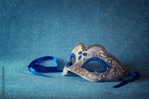 blue female carnival mask and glitter background. with glitter overlay 