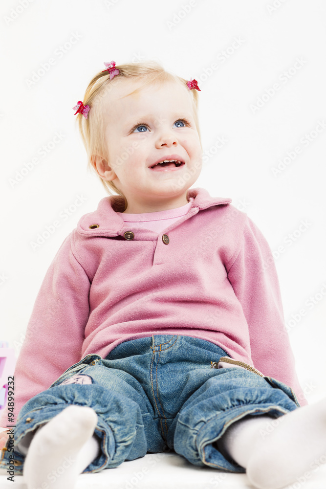 portait of sitting little girl wearing jeans portait of sitting little girl wearing jeans