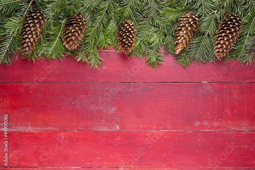 Christmas background

Christmas fir tree branches on a red background.