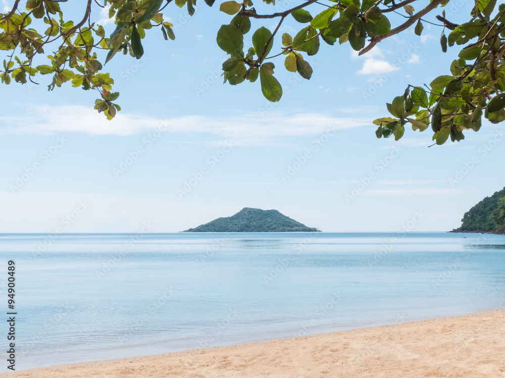 Fototapeta premium Island located on the sea with tree leaf foreground and copy spa