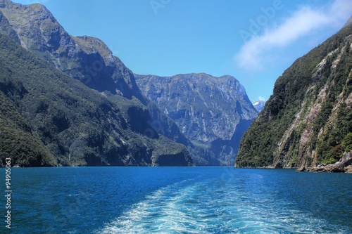Ferry trip through Milford Sound in New Zealand on a sunny day