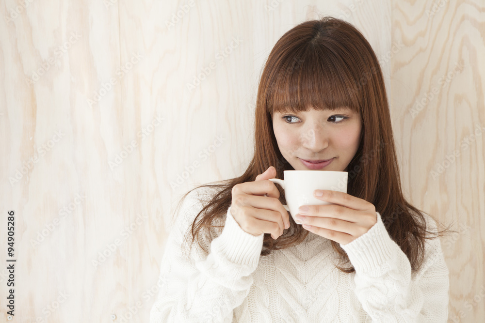 Young women are drinking hot coffee