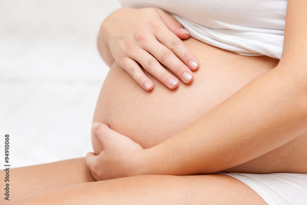 Pregnant woman touching her belly