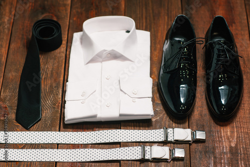 Black tie , patent leather shoes , suspenders, a white shirt photo