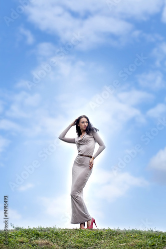 Young woman in sexy long gray dress