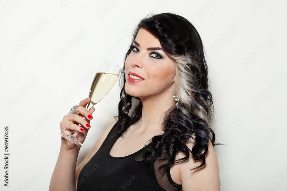 Beautiful young woman.celebrating with a glass of champagne Beautiful young woman.celebrating with a glass of champagne