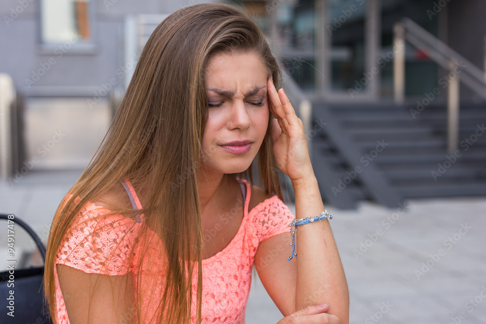 Fototapeta premium Young woman have a terrible headache. It can be migraine.