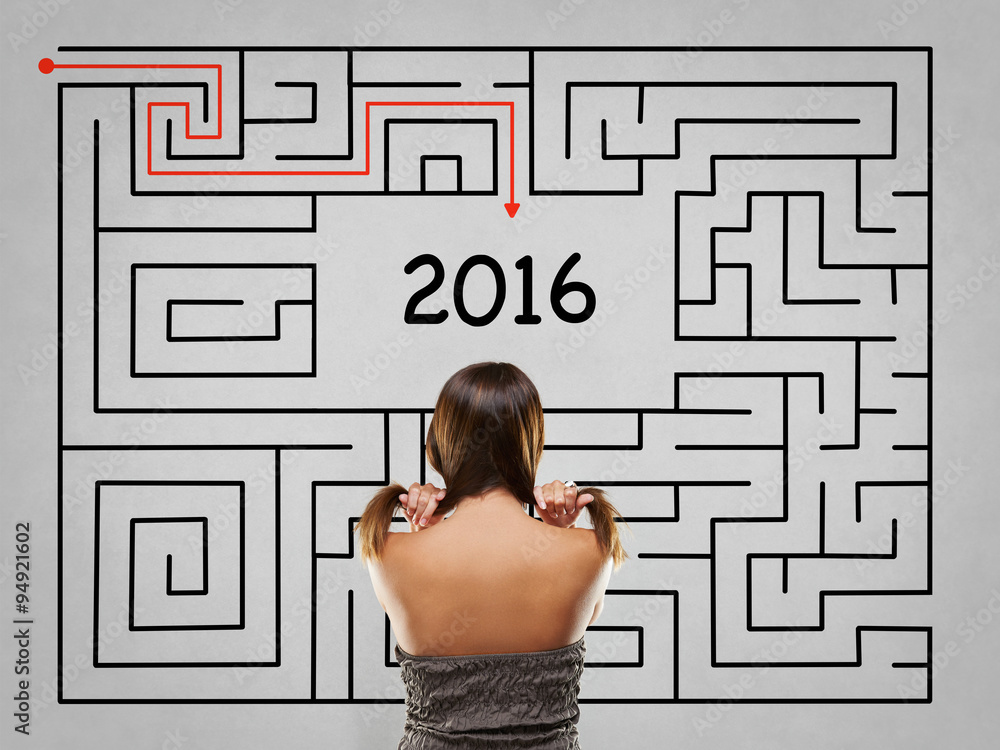 Woman pulling hair in front of labyrinth with 2016 solution Woman pulling hair in front of labyrinth with 2016 solution