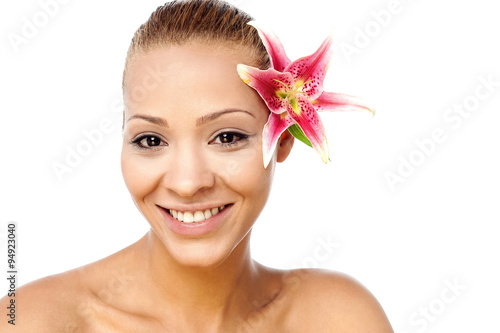 Attractive lady with a lily flower on hair
