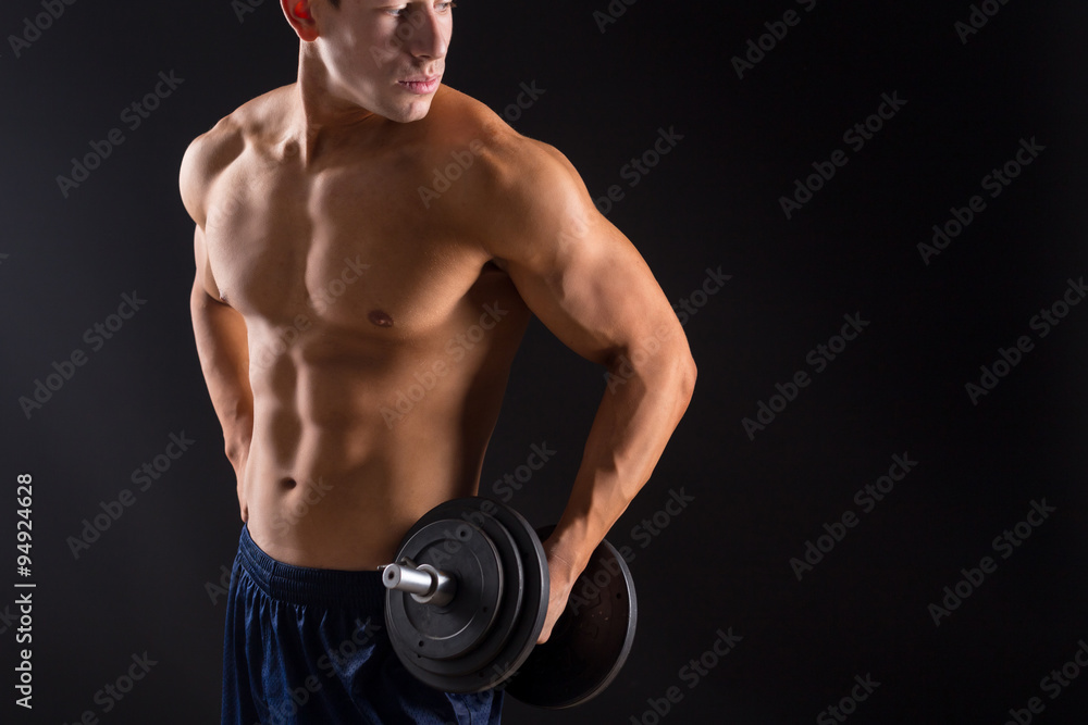 strong athletic man on black background
