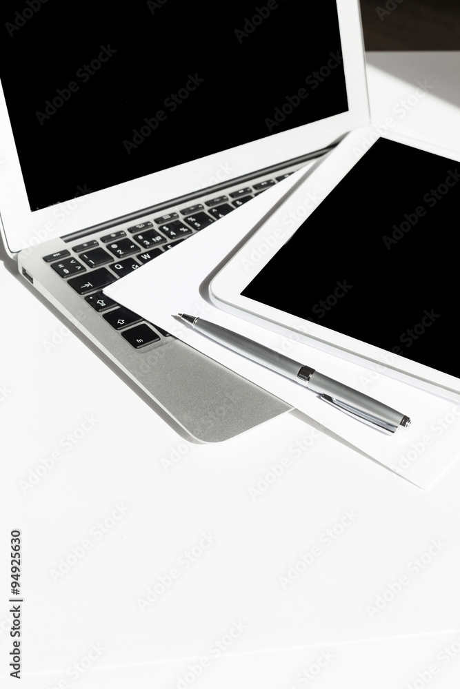 Open laptop with digital tablet and white smartphone Open laptop with digital tablet and white smartphone