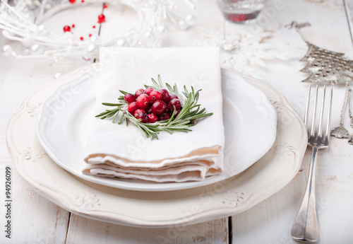 Christmas And New Year Holiday Table Setting with cranberry decoration. 