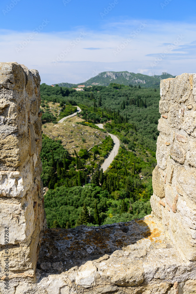 Country curvy road seen from Angelokastro walls, Corfu, Greece.