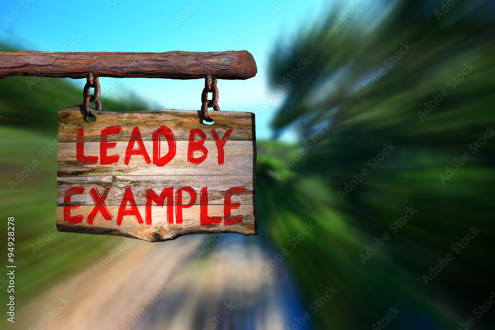 Fototapeta premium Lead by example motivational phrase sign