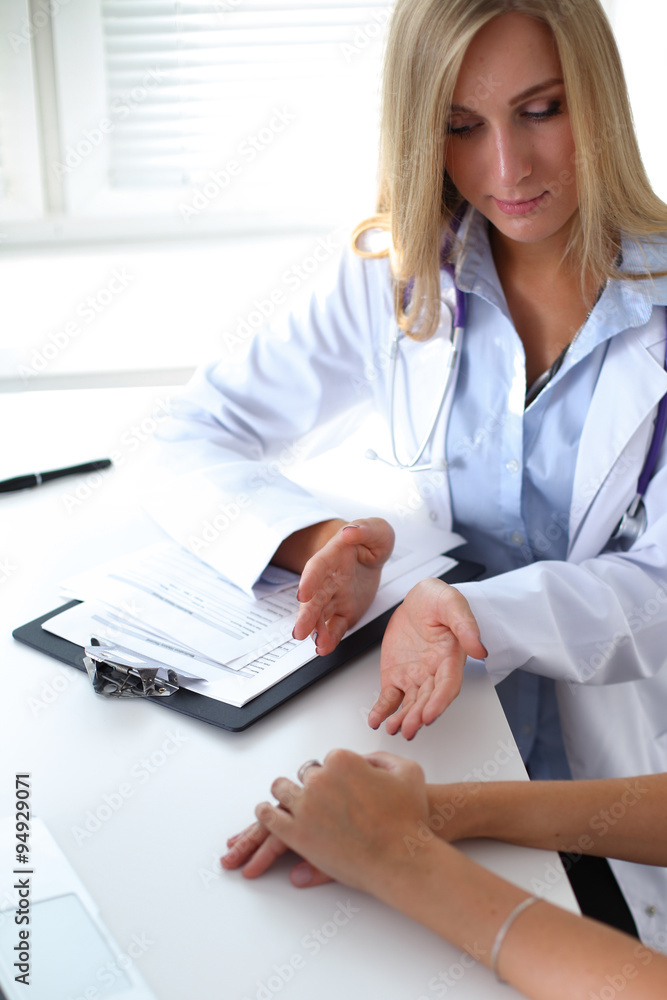 Doctor and patient are discussing something, just hands at the table Doctor and patient are discussing something, just hands at the table