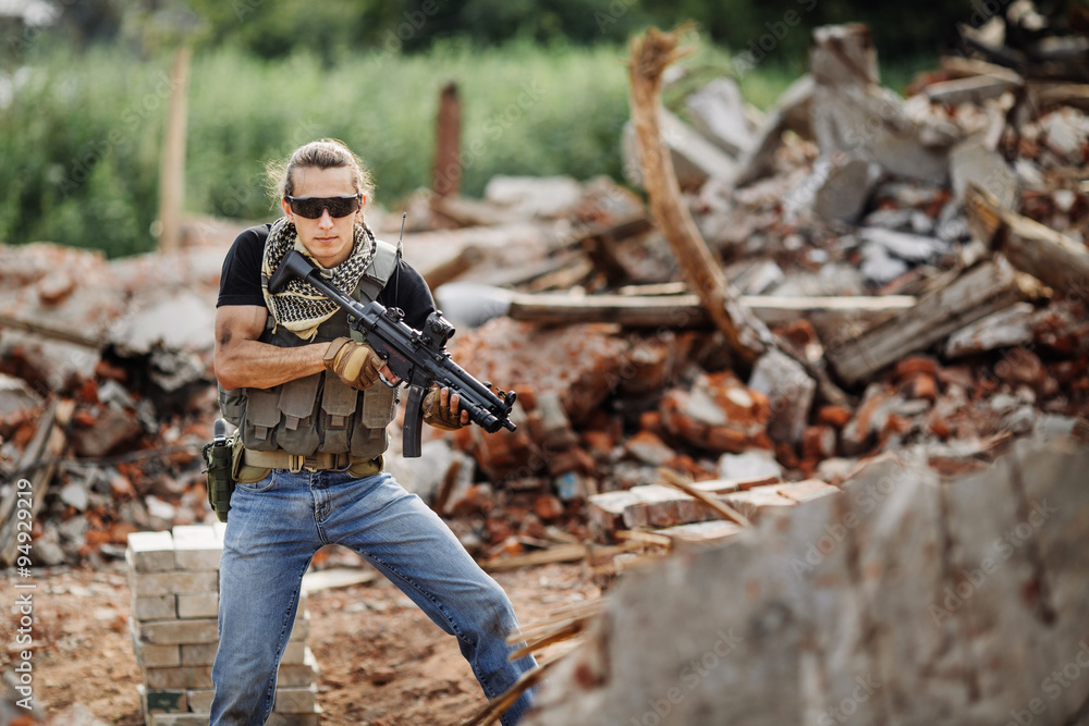 Fototapeta premium Private Military Contractor on patrol in destroyed city