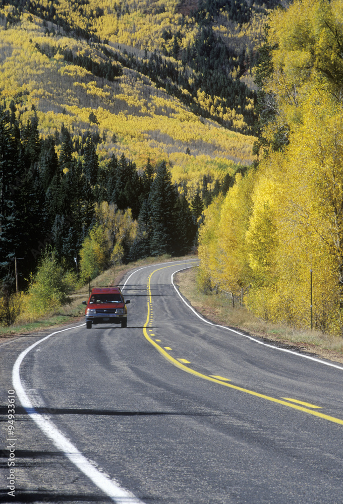 Fototapeta premium A truck traveling in autumn on Route 145 in Colorado