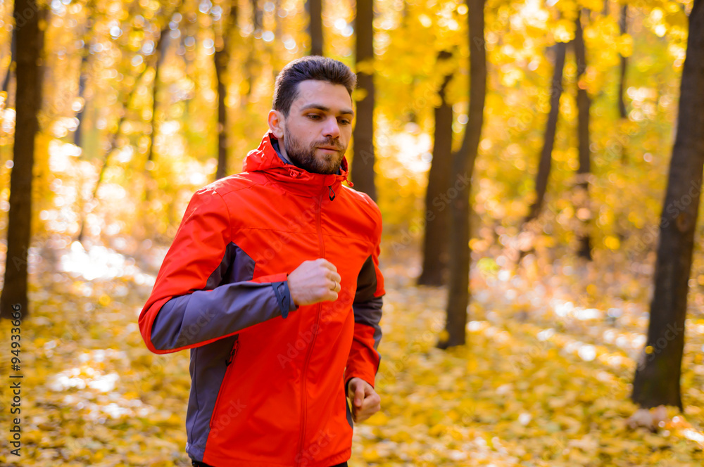 Young Man Running on Sunny Trail in the Beautiful Autumn Oak Forest Young Man Running on Sunny Trail in the Beautiful Autumn Oak Forest