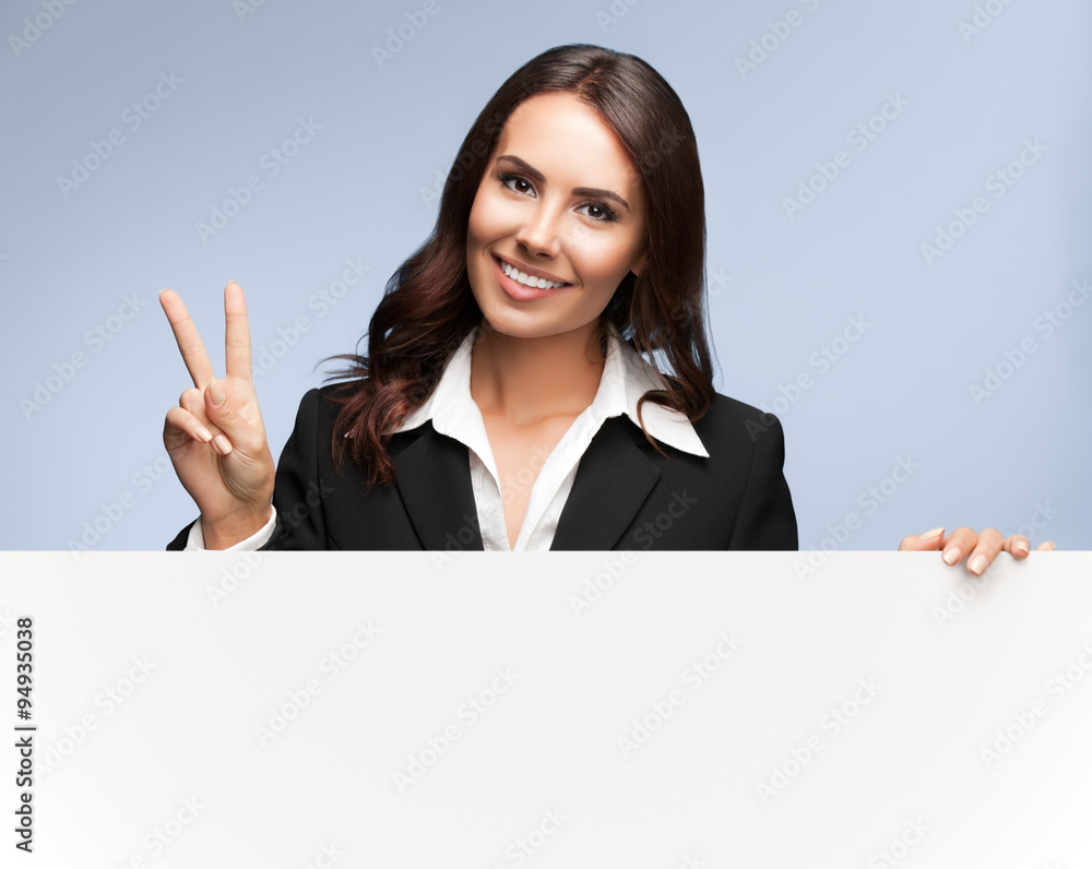 businesswoman showing blank signboard on grey businesswoman showing blank signboard on grey