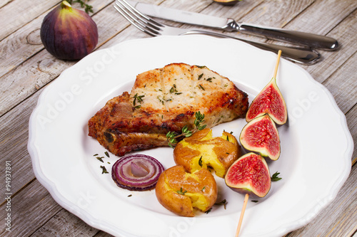 Grilled Pork Chop with Figs on Scewer, Crisp Roasted Potatoes and Thyme photo