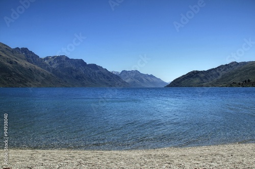 Blue lake and mountains in lake Wakatipu, New Zealand