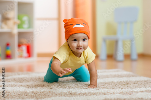 crawling baby boy at home on floor photo