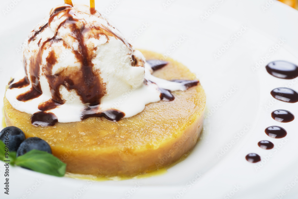 delicious dessert scoop of ice cream on a hot sherbet served on a white plate on a wooden table in a restaurant delicious dessert scoop of ice cream on a hot sherbet served on a white plate on a wooden table in a restaurant