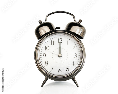 Twelve on an old vintage alarm clock isolated on white background