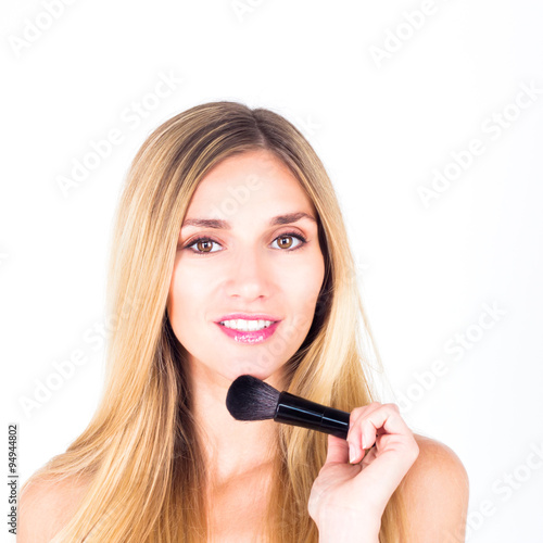 Happy smiling with teeth woman holding brush for rouge. Make-up close up.