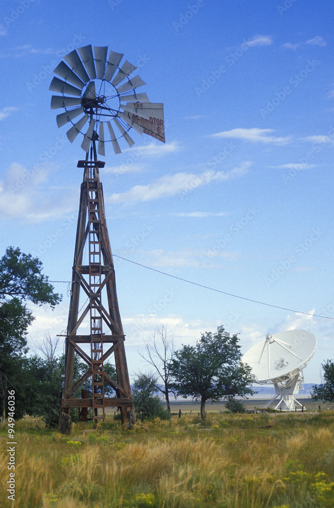 Radio telescope and old windmill at the National Radio Astronomy Observatory in Socorro, NM Radio telescope and old windmill at the National Radio Astronomy Observatory in Socorro, NM