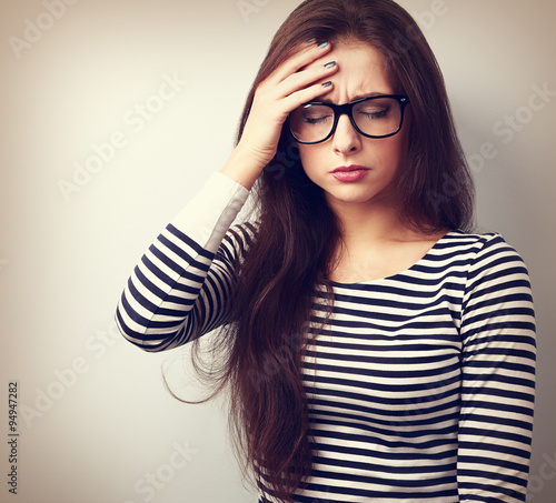 Fotografie Beautiful business woman with headache holding head the hand wit
