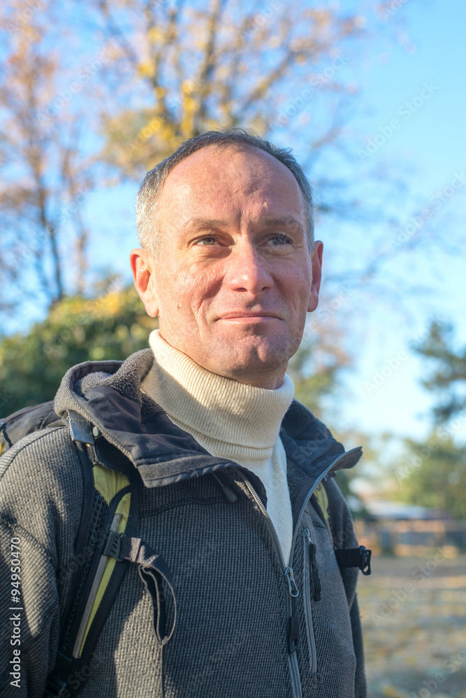 Portrait of active man with backpack relaxing in a autumn park, Portrait of active man with backpack relaxing in a autumn park,
