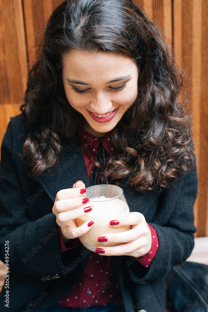 Happy woman having a coffee with milk Happy woman having a coffee with milk