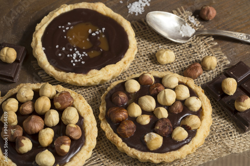 Chocolate and caramel tarts with hazelnuts