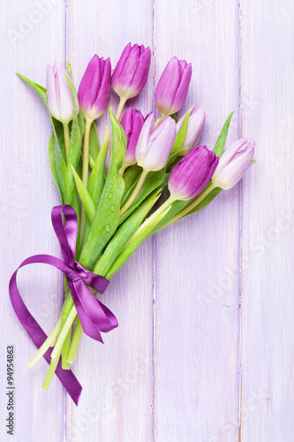 Fototapeta Naklejka Na Ścianę i Meble -  Purple tulips over wooden table