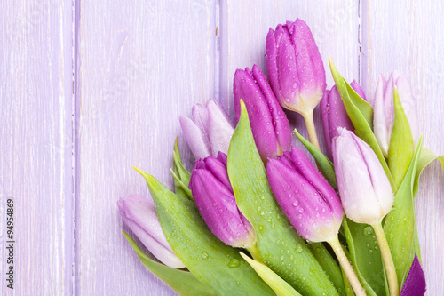 Fototapeta Naklejka Na Ścianę i Meble -  Purple tulips over wooden table
