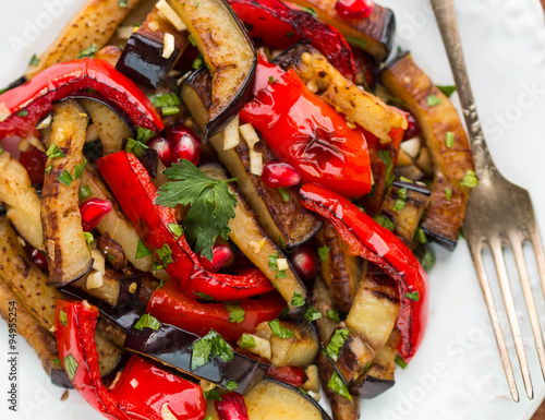 Salad of baked vegetables. Eggplant and bell peppers with pomegr