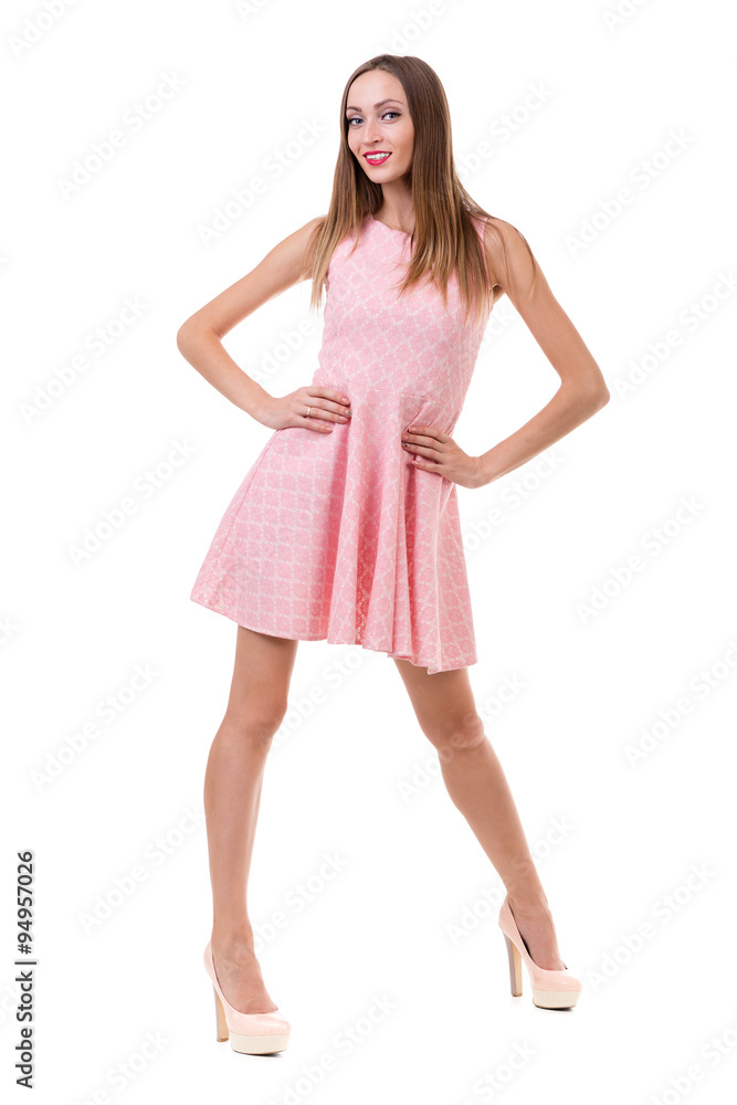 Full length of sensual woman in short dress dancing against isolated white Full length of sensual woman in short dress dancing against isolated white