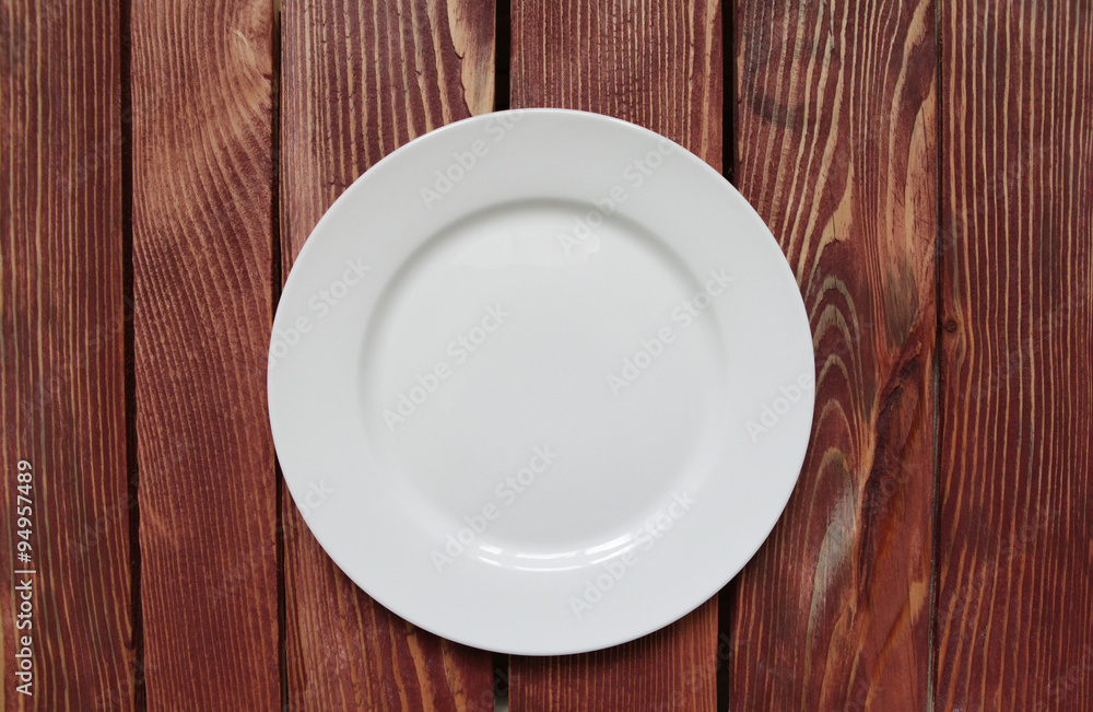 white empty plate on wooden table white empty plate on wooden table